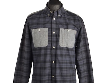 May include: A long-sleeved plaid shirt with a button-down collar and two large patch pockets on the chest. The pockets are a contrasting gray color.