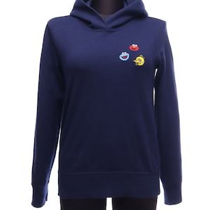 May include: A navy blue hooded sweatshirt with embroidered Sesame Street characters on the front. The characters include Cookie Monster, Elmo, and Big Bird.