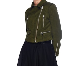 May include: A green suede jacket with a zipper closure and multiple pockets. The jacket has a cropped length and a slightly fitted silhouette.