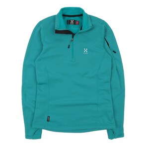May include: Teal-colored fleece pullover with a half-zip closure. Features a stand-up collar with a black trim and a small logo on the chest. Includes a small zippered pocket on the left sleeve. The garment is designed for outdoor activities.
