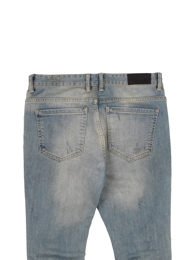 May include: A pair of light blue denim jeans with distressed details and a black leather patch on the back.