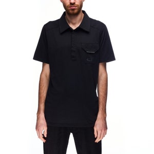 May include: A black short-sleeved polo shirt with a button-up collar and a small pocket on the left chest. The pocket has a small logo on it.