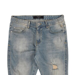 May include: Light blue distressed denim jeans with rips and tears throughout. The jeans have a black label with the text "REPRESENT" on the waistband.