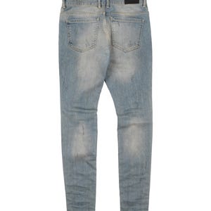 May include: Light blue denim jeans with distressed details and a faded look. The jeans have a slim fit and a straight leg.