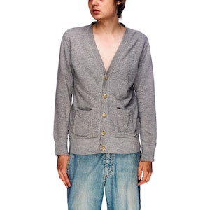 May include: A gray cardigan with a v-neck and five gold buttons. The cardigan has two pockets on the front.