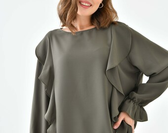 May include: A long-sleeved, olive green blouse with ruffles on the shoulders and cuffs. The blouse has a round neckline and is made of a soft, flowing fabric.