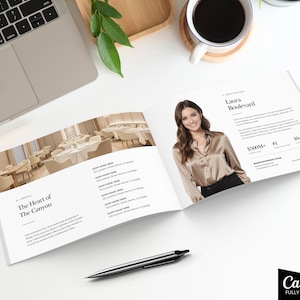 May include: Open brochure with a photo of a woman in a silk shirt, and text that reads "Laura Boulevard". The brochure also features a restaurant interior and the text "The Heart of The Canyon". A laptop, pen, and coffee cup are also visible.