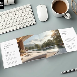 May include: An open brochure with images of a luxury home and pool, with text that reads "Manhattan Beach" and "Neighborhood Features." A keyboard, mouse, and coffee cup are also visible.