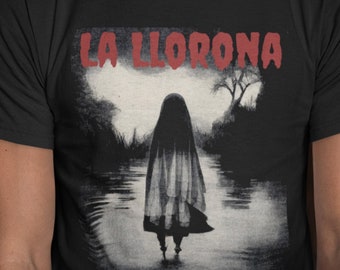 May include: Black t-shirt featuring a grayscale illustration of a spectral figure in water, with the red text "LA LLORONA" above. The design evokes a spooky, supernatural theme, perfect for fans of horror and folklore.