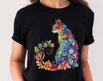 May include: Black t-shirt with a colorful cat design. The cat is surrounded by flowers and has a blue, green, and purple color scheme.