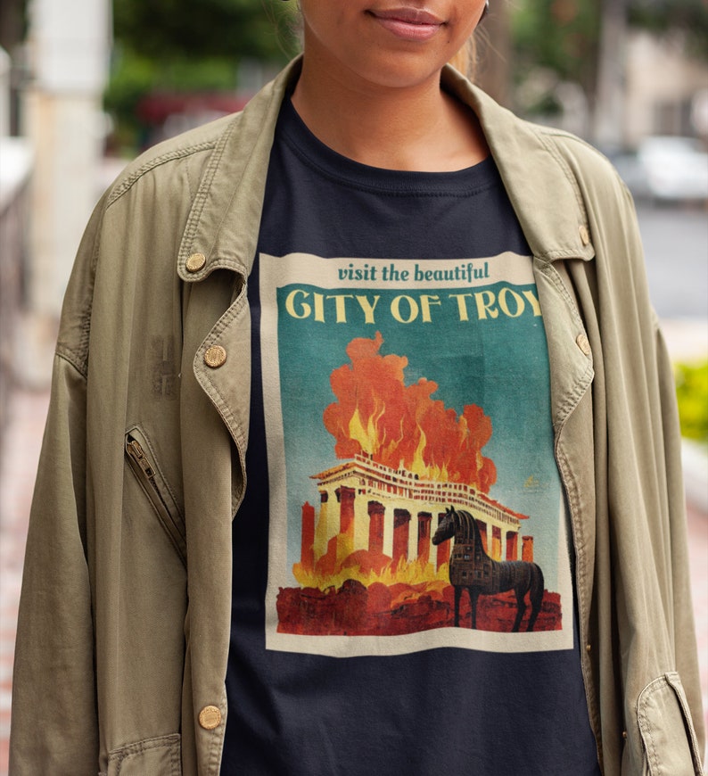 May include: A black t-shirt with a vintage-style graphic of a burning city with the text "visit the beautiful CITY OF TROY" above the image.