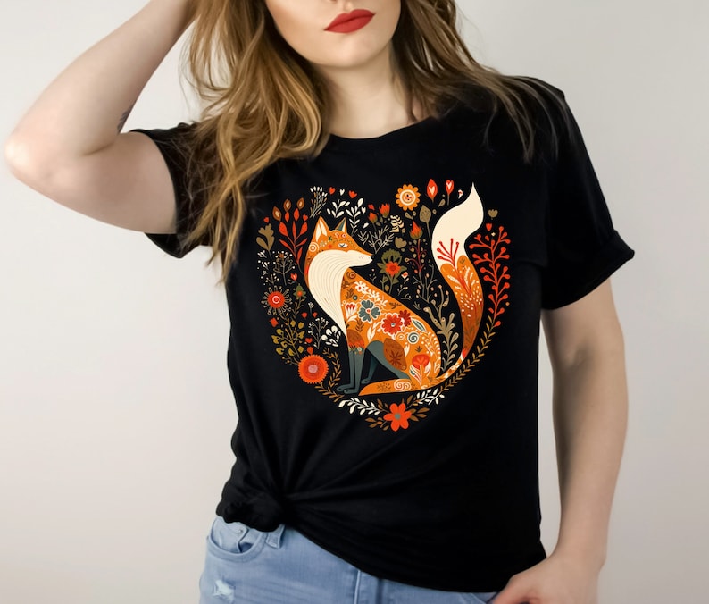 May include: Black t-shirt with a colorful fox illustration surrounded by flowers in a heart shape.