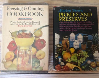 May include: Two vintage cookbooks, one titled "Freezing & Canning Cookbook" with a revised edition label and the other titled "Marion Brown Pickles and Preserves" with over 300 recipes for preserves, pickles, relishes, conserves, jellies, marmalades, chutneys, jams, fruit butters, pickled meats, mincemeats, catsups, sauces, and candied fruits.
