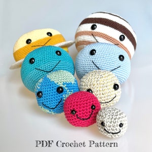 May include: A set of crocheted planets with smiling faces. The planets are in different colors and sizes, including yellow, blue, brown, white, and red. The planets are arranged in a line, with the largest planet at the top and the smallest planet at the bottom. The planets are all crocheted with a textured yarn.  PDF Crochet Pattern