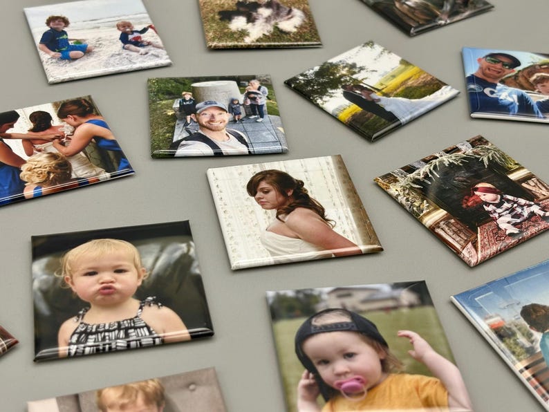 May include: A collection of square photo magnets with various images, including a family portrait, a wedding photo, a child in a dress, and a dog.
