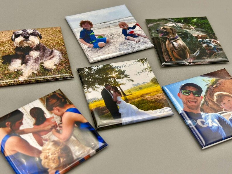 May include: A set of 10 square photo magnets featuring various images, including a wedding couple, a family at the beach, a dog, and a man with sunglasses. The magnets are printed on a glossy surface and have a white border.