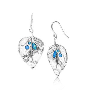 May include: A pair of silver leaf-shaped earrings with blue opal accents. The earrings have a textured surface and a hook closure. The opal stones are set into the leaf design, adding a pop of color to the jewelry.