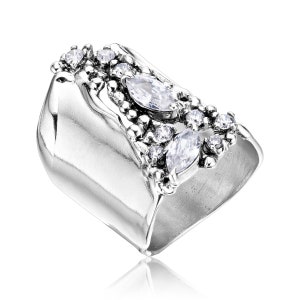 May include: A silver ring with a textured band and a cluster of clear marquise and round-shaped cubic zirconia stones.