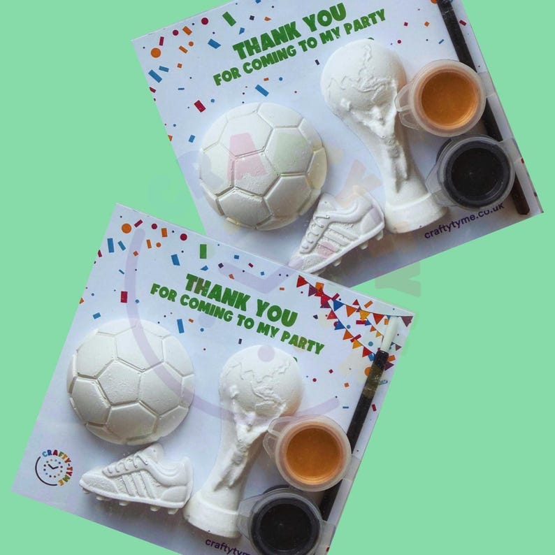 May include: Two party favor sets with a soccer theme. Each set includes a soccer ball, a trophy, a sneaker, two paint pots, and a paintbrush. The text "THANK YOU FOR COMING TO MY PARTY" is printed on the card.