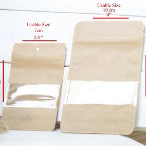 May include: Two brown paper bags with clear plastic windows and zipper closures. The smaller bag measures 4.3 inches by 2.8 inches and the larger bag measures 6 inches by 4 inches.