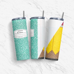May include: Three stainless steel tumblers with different designs. The first tumbler has a green and white composition notebook pattern with the text "COMPOSITION" and "Mrs. Wilson". The second tumbler has a white and blue composition notebook pattern with a hole punch on the side. The third tumbler has a white and blue composition notebook pattern with a yellow pencil design.