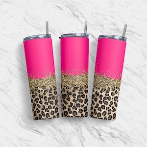 May include: Three pink tumblers with gold glitter and leopard print design. Each tumbler has a silver straw and a black lid. The tumblers are cylindrical and appear to be made of stainless steel.