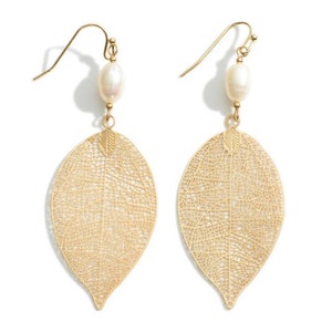 May include: Gold leaf earrings with a delicate, intricate design and a single white pearl accent on each earring.
