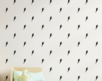 May include: A white wall with a repeating pattern of black lightning bolt decals.