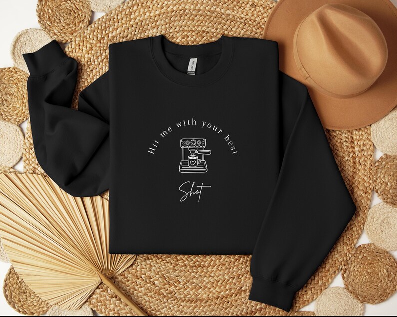 May include: Black sweatshirt with a white graphic of a coffee maker and the text "Hit me with your best shot".