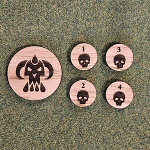 May include: Four wooden tokens with a skull design and numbers 1 through 4. A larger wooden token with a skull design and a symbol above it.