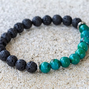 May include: A black lava rock and green gemstone beaded bracelet with silver metal spacers.