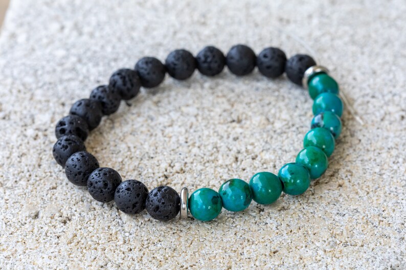 May include: A black lava rock and green gemstone beaded bracelet with silver metal spacers.