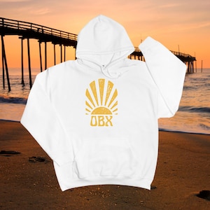 May include: White hooded sweatshirt with a yellow sun and the text "OBX" printed on the front.