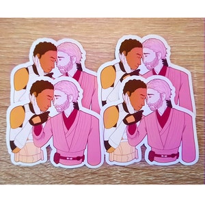 May include: Four pink and white stickers featuring a cartoon couple embracing. The couple is made up of a person with brown skin and a person with white skin. Both are wearing pink robes.