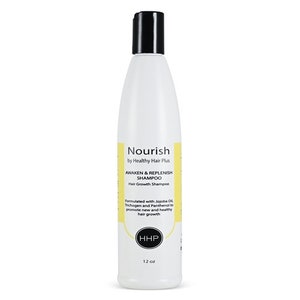 May include: A white plastic bottle of Nourish Awaken & Replenish Shampoo by Healthy Hair Plus. The bottle is labeled with a yellow background and black text. The bottle contains 12 ounces of shampoo.