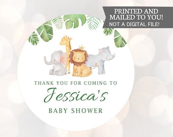 May include: Round thank you sticker with a jungle theme. It features a lion, elephant, giraffe, and rhinoceros with green leaves and the text "Thank you for coming to Jessica's Baby Shower".
