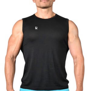 May include: Black sleeveless athletic shirt with a small white logo on the chest. The shirt is paired with light blue athletic shorts. The model is standing in front of a white background. The shirt is made of a lightweight, breathable material.