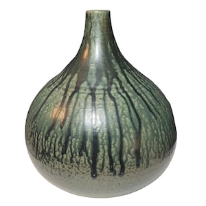 May include: A round ceramic vase with a narrow neck, featuring a mottled sage green glaze on the upper portion with dark black vertical drip patterns that cascade downward, transitioning into a textured, speckled light tan base at the bottom.