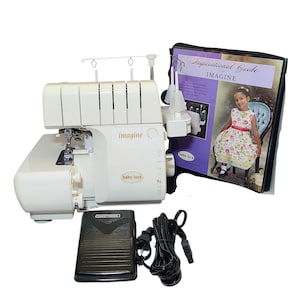 May include: A white Baby Lock Imagine serger sewing machine with a black foot pedal and power cord. An "Inspirational Guide" booklet is included. The machine has the word "imagine" printed on it.