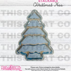 May include: A clear plastic mold of a Christmas tree with three tiers. The mold is designed to be stacked, creating a multi-layered Christmas tree decoration.
