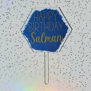May include: A blue and gold hexagonal cake topper with the text "Happy Birthday Salman".