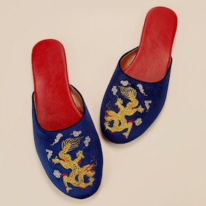 May include: A pair of blue velvet slippers with red lining and gold embroidered dragons.