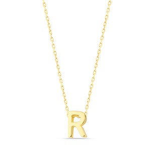 May include: A gold chain necklace with a gold letter R pendant.