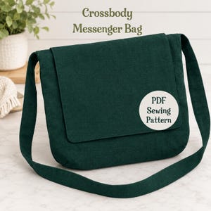May include: A dark green crossbody messenger bag with a long shoulder strap and a front flap. A circular white label on the front flap features the black text "PDF Sewing Pattern". The text "Crossbody Messenger Bag" appears above the bag.