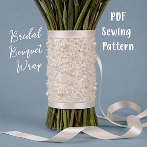 May include: A bridal bouquet wrap featuring white lace with floral embroidery and scattered pearls, secured with satin ribbon. The text reads: Bridal Bouquet Wrap, PDF Sewing Pattern. The wrap is shown around green flower stems.