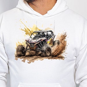 May include: White hooded sweatshirt with a graphic print of a black and yellow off-road vehicle driving through dirt.