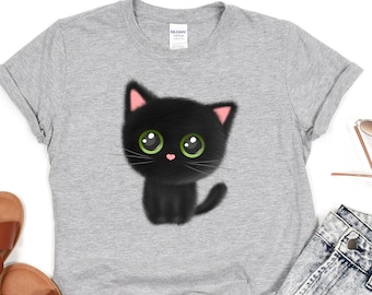 May include: A gray t-shirt with a black cat with green eyes and pink cheeks. The cat is wearing a cute expression.