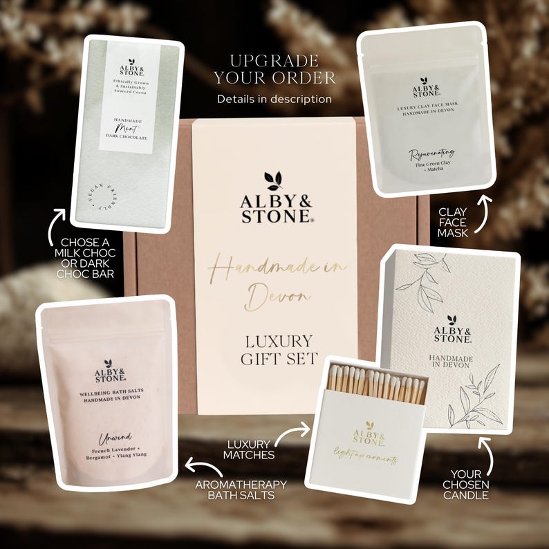 The image is a promotional material for a luxury gift set from Alby & Stone, featuring various items such as a chocolate bar, a face mask, a clay mask, a matchbox, and a candle.