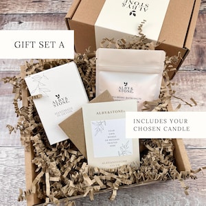 A gift set containing a box, a card, and a bag, all wrapped in brown paper and placed in a cardboard box with shredded paper.