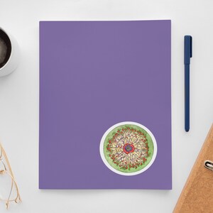 May include: A colorful sticker with a circular design featuring a flower with red, yellow, and green petals. The flower is surrounded by a green circle with a white border.